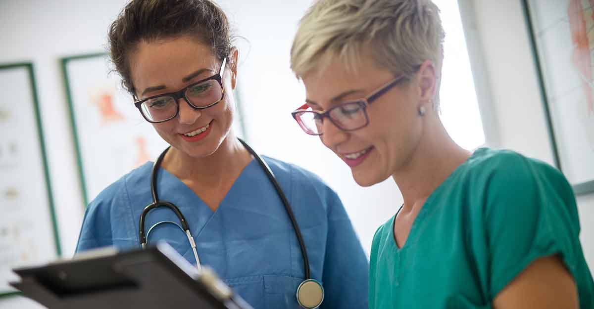 Two women looking at clipboard