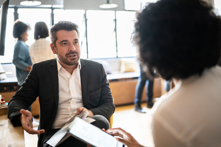 Man talks to colleague about marketing to Generation X